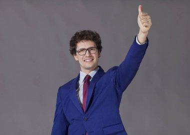 Mavi ceket ve kravat büyük başparmak gösterilmesini bir çocuk