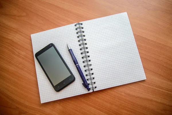 Notepad with pen and phone — Stock Photo, Image