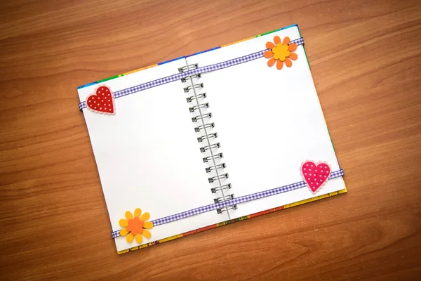 Opened notepad with hearts and flowers — Stock Photo, Image