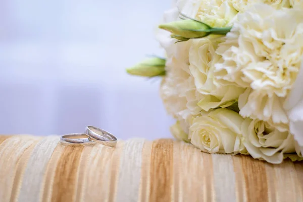 Engagement rings and wedding bouquet