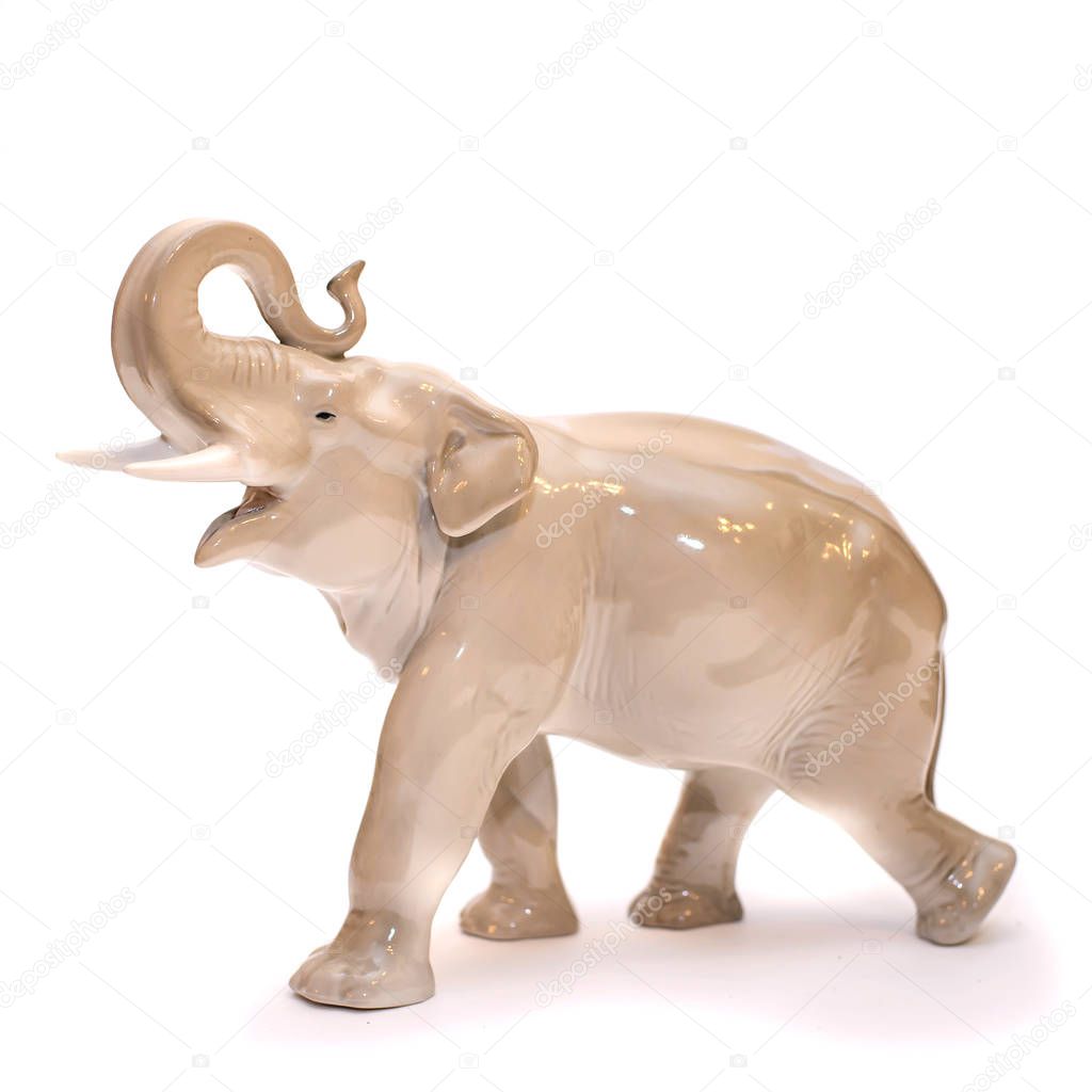 Porcelain figurine of a large elephant, isolate on a white background