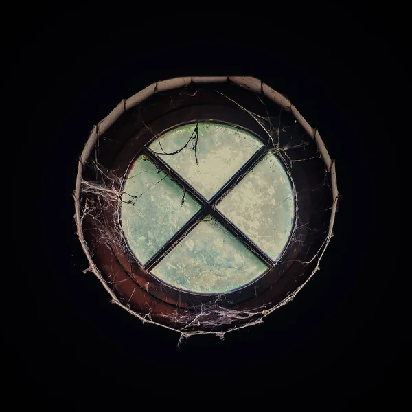 Old round window in the attic, inside view