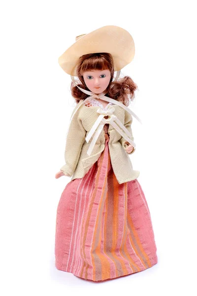 Porcelain doll in vintage outfit and hat — Stock Photo, Image