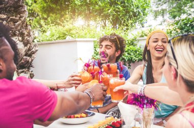 Mutlu arkadaşlar dışarıda eğleniyor. Bir grup insan ev partisinde kokteyl ile kadeh kaldırıyor.