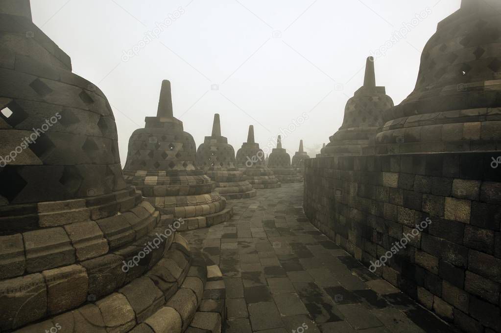 Borobudur, is a 9th-century Mahayana Buddhist temple in Magelang, Central Java, Indonesia. The monument consists of nine stacked platforms, six square and three circular, topped by a central dome.