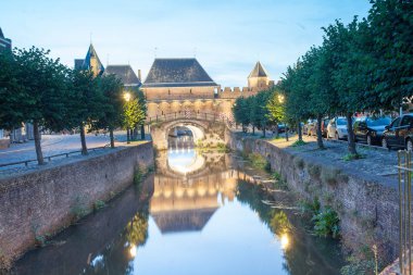 Akşam binalar ile cityscape, nehir yansıma, aydınlatma ve arabalar 