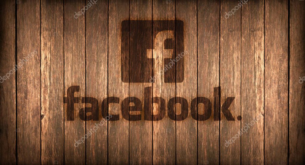 Logo of a famous social networks printed on fire on a wooden board