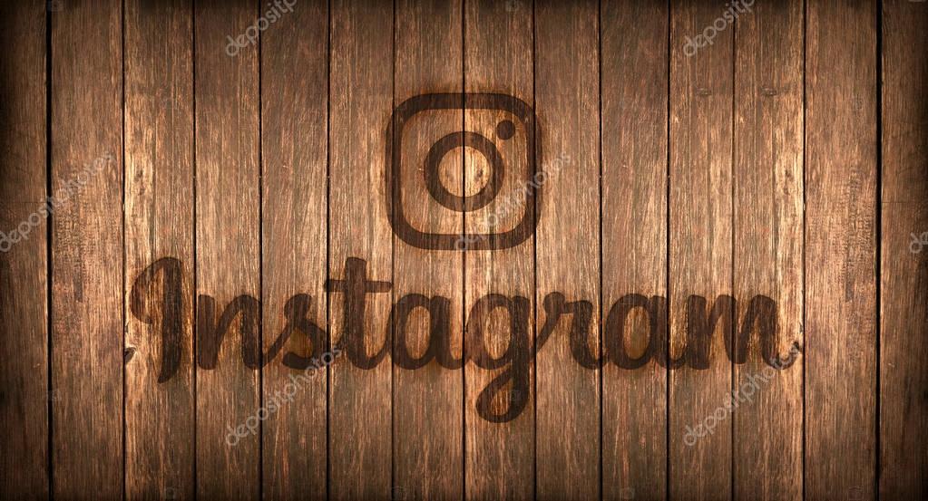 Logo of a famous social networks printed on fire on a wooden board