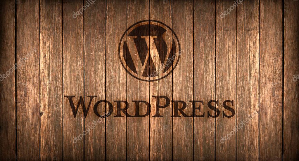 Logo of a famous CMS printed on fire on a wooden board