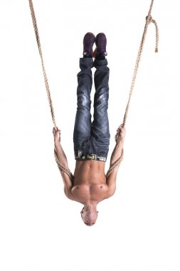 A man hangs on the ropes upside down isolated on white background clipart