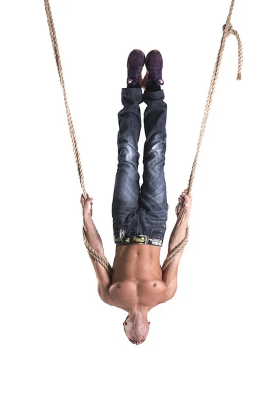 A man hangs on the ropes upside down isolated on white background — Stock Photo, Image