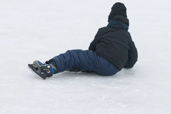 Enfant tombé sur la patinoire d'hiver — Photo