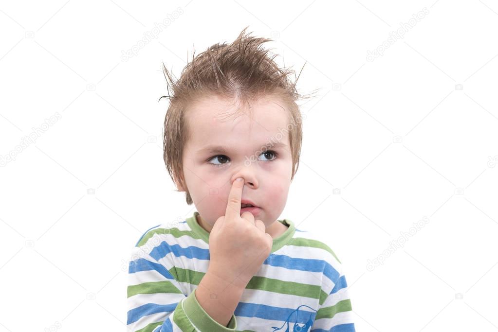 Handsome little boy picking his nose isolated on white background