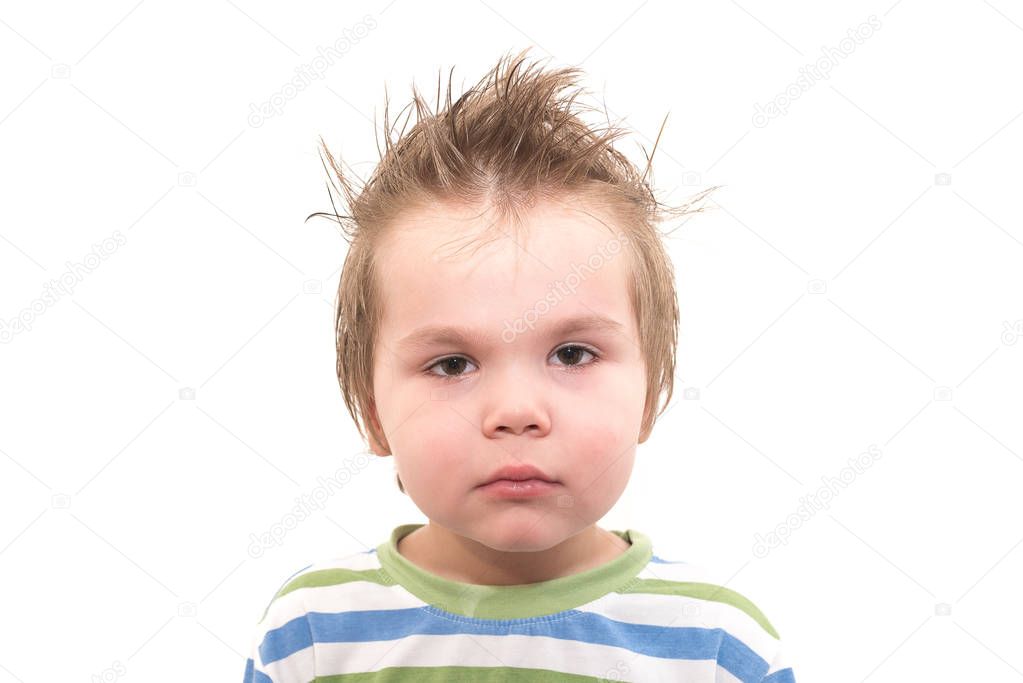Sad, small, handsome boy with tears in his eyes isolated on white background