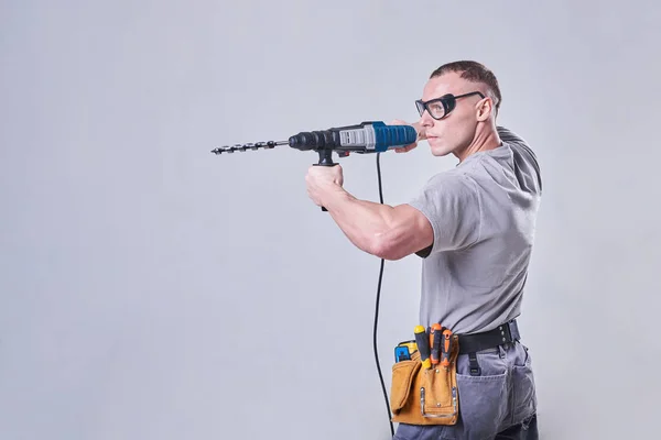 Master Builder-finalizador en ropa de trabajo, con un perforador en las manos — Foto de Stock