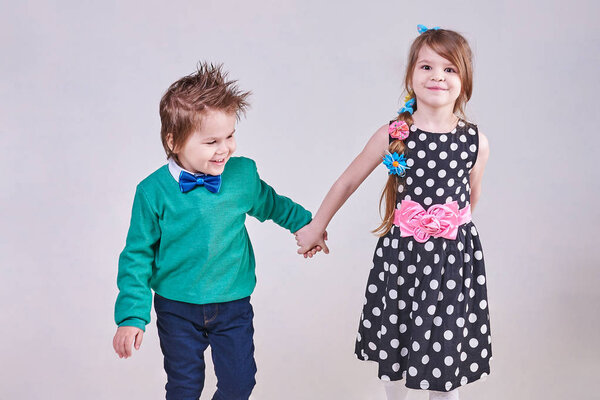 Beautiful little boy and girl holding hands