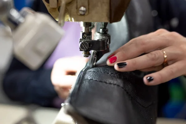 The process of sewing shoes on a sewing machine. Shoe production.