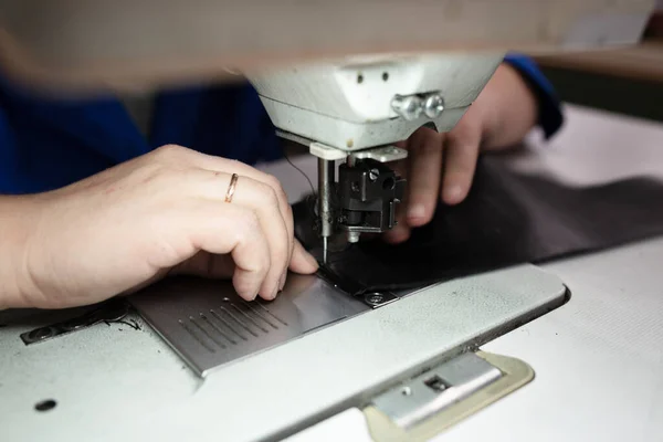 The process of sewing shoes on a sewing machine. Shoe production.