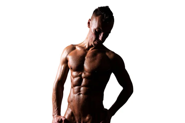Αθλητικός, μαυρισμένος άντρας με γυμνό κορμό, ποζάρει και κοιτάει κάτω. Απομονωμένα σε λευκό φόντο. — Φωτογραφία Αρχείου