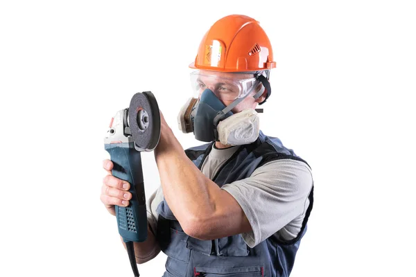 Builder in a helmet and a respirator, with an angle grinder in his hands. — Stock Photo, Image