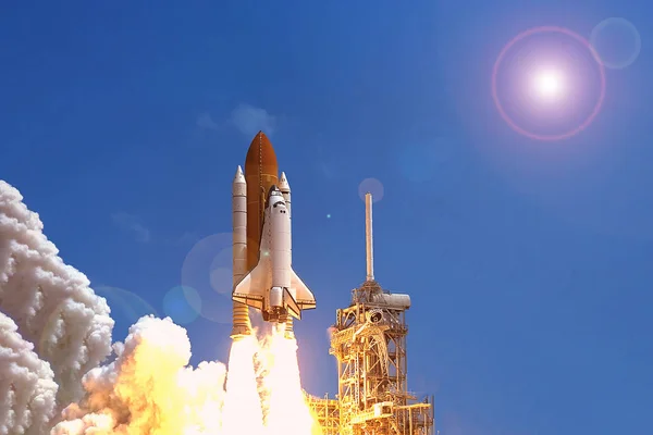 Take off space rocket on a background of blue sky and sun. Elements of this image were furnished by NASA — Stock Photo, Image