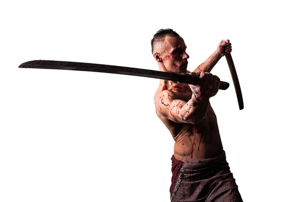 Un uomo atletico, nel sangue, con una spada giapponese, mostra tecniche di combattimento. Isolato su sfondo bianco . — Foto Stock