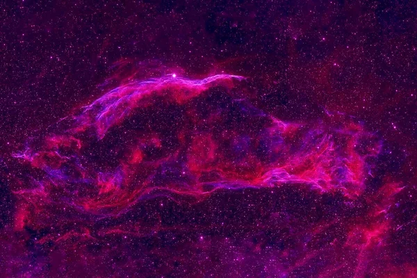 A beautiful pink galaxy in deep space. Elements of this image were furnished by NASA.