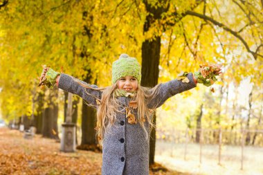 küçük kız sonbaharda yürür