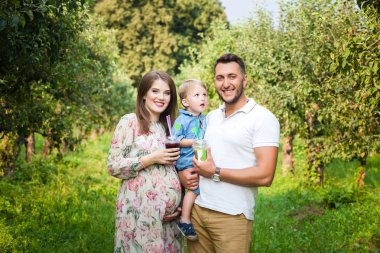 Genç çekici aile bir çayırda yürüyüş ve suyu içme