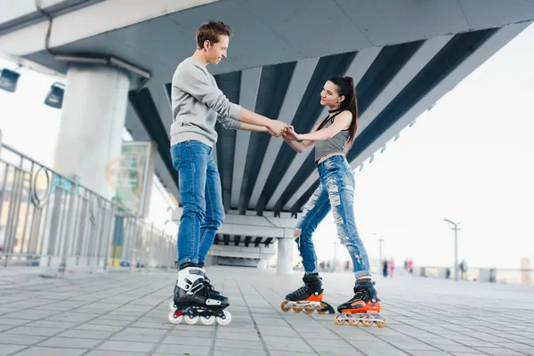 Bonito casal doce montando em patins — Fotografia de Stock