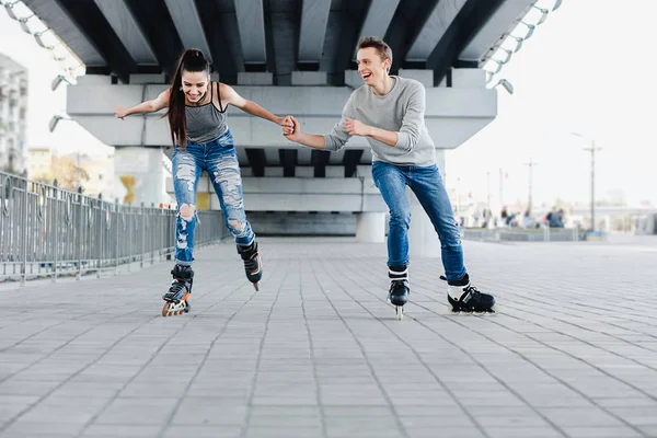 Beautiful sweet couple riding on roller skates