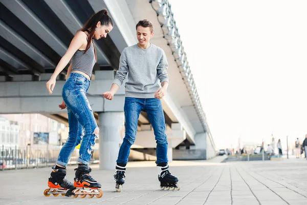 Beautiful sweet couple riding on roller skates