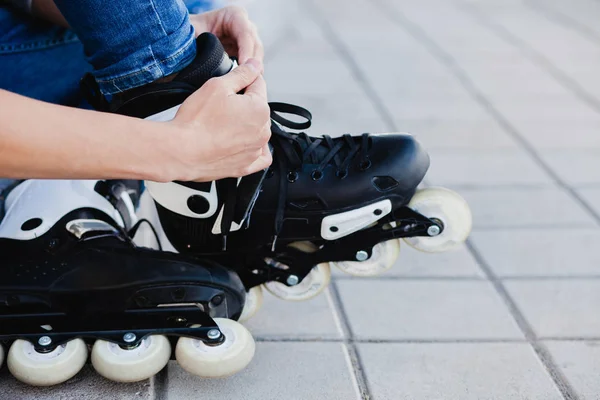 Nahaufnahme eines Mannes, der im Freien Rollschuhe anzieht. — Stockfoto