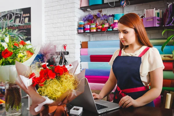 在一家花店工作的年轻女孩 — 图库照片