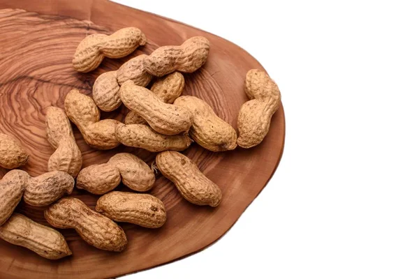 Peanuts in a shell on a wooden board isolated on a white background — Stock Photo, Image