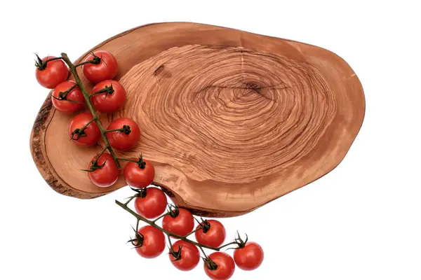 Cherry tomatoes lie on a wooden board of drying oil, isolated on white background — Stock Photo, Image