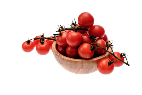 Red cherry tomatoes lie in a wooden cup, isolated on a white background — Stock Photo, Image