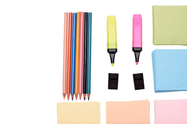 Colored pencils and markers with paper for writing isolated on white background — Stock Photo, Image