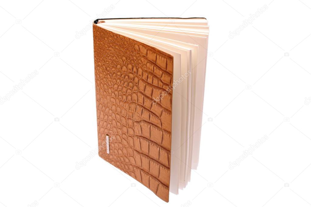 Notebook with cover made of crocodile skin isolated on white background