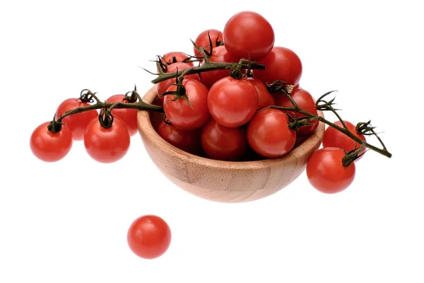Tomates cereja vermelha encontram-se em uma xícara de madeira, isolado em um fundo branco — Fotografia de Stock