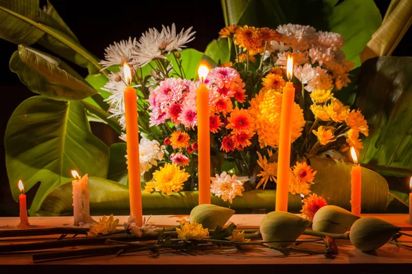 fire on candles and a group of flowers to pray for the dead king