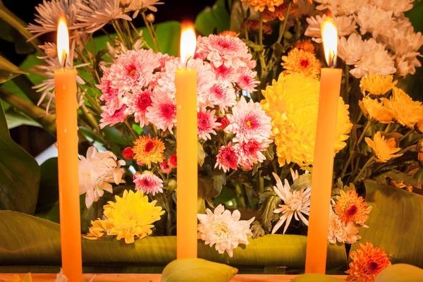 fire on candles and a group of flowers to pray for the dead king