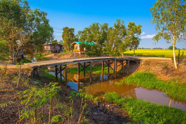 Old wooden bridge across a canal — Stock Photo, Image