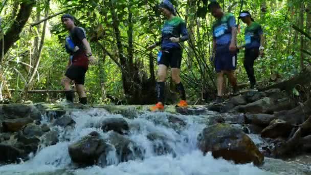 Athletic run across forest and waterfall for run racing in Khao Phra Thaeo national park. — Stock Video