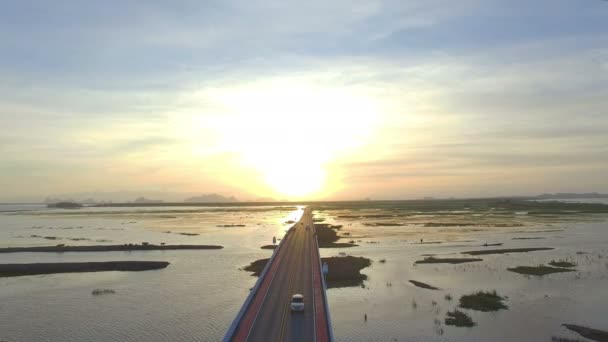 一个人驾驶他的无人机在桥上 而长尾船通过下的长桥在途中去鸟看塔在塔河内 Phattalung — 图库视频影像