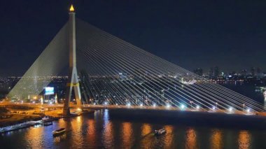 turist tekneleri Chao Phraya River Praram sekiz Köprüsü'nün altında geceleri geçmek. Rama 8 köprü Bangkok Tayland Chao Phraya nehri geçerken bir kablo kaldı köprüdür.