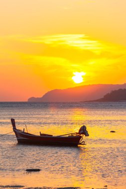 Rawai Denizi 'ndeki balıkçı teknelerinin üzerinde güzel altın gün doğumu. Phuket Tayland..