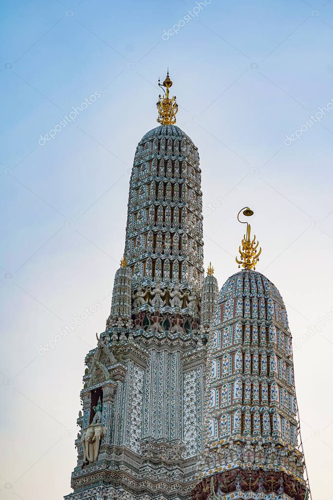 Large illuminated temple Wat Arun after sunset seen accross river Chao Phraya Bangkok, Thailan