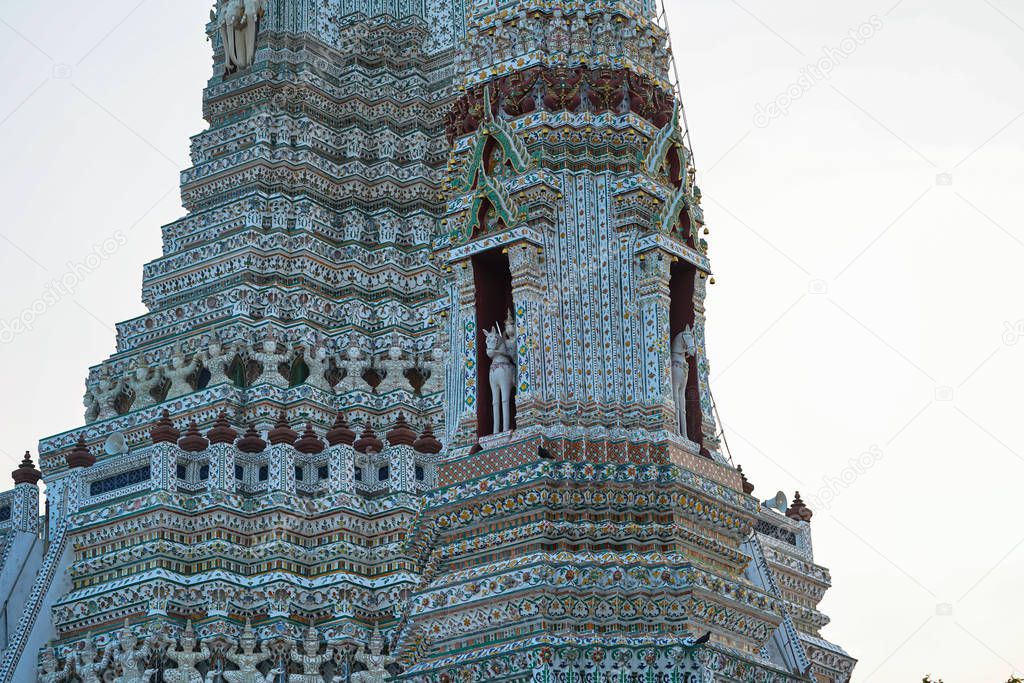 Large illuminated temple Wat Arun after sunset seen accross river Chao Phraya Bangkok, Thailan