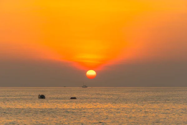 round red sun down to the sea at Patong beach, Phuket,Thailand.